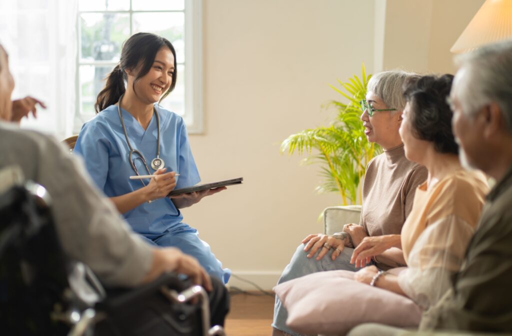 A nurse talks with a group of seniors in an assisted living community to ensure their needs are being met